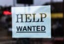 Alcorn County Unemployment at 2.9% in August, Below State Help Wanted sign in a store window, illustrating Alcorn County unemployment figures