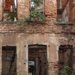 Corinth Property Cleanup Targets Old Lusk Funeral Home Abandoned red brick building with broken windows, illustrating Corinth property cleanup of vacant structures
