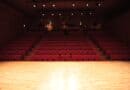 Corinth Theatre-Arts Eviction Stands After Appeal Fails Empty theater with rows of red seats facing a lit stage, illustrating the Corinth Theatre-Arts eviction