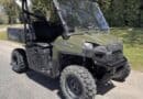 Crime Stoppers asks for tips on stolen Polaris Ranger in Prentiss County A green Polaris Ranger utility vehicle parked outdoors on a paved road beside grass and trees.