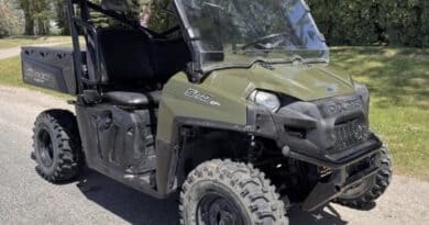 Crime Stoppers asks for tips on stolen Polaris Ranger in Prentiss County A green Polaris Ranger utility vehicle parked outdoors on a paved road beside grass and trees.