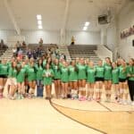 Kossuth Volleyball honors Mason Mills with 54 seconds of silence, then sweeps Alcorn Central Kossuth volleyball players, coaches and supporters stand at midcourt in green KOSSUTH 54 shirts honoring Mason Mills before a district match against Alcorn Central.