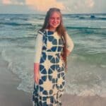 NEMCC Adult Education profiles Shiloh’s route to pharmacy work A young woman stands on a beach wearing a patterned dress.