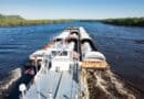 Yellow Creek Port Expansion Underway in Tishomingo County Cargo barge moving freight on a river, illustrating the Yellow Creek Port expansion