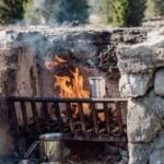 The 5 Best Cast Iron Dutch Ovens for Alcorn County Campfire Cooking Metal pots sizzling over an open campfire — classic campfire cooking with cast iron