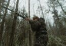The 5 Best Insulated Coveralls for Alcorn County Deer Season Hunter in camouflage gear in a winter forest during deer season