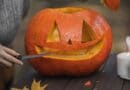 The 5 Best Pumpkin Carving Kits for Alcorn County Families A person carving a pumpkin into a jack-o'-lantern on an outdoor wooden table with autumn leaves.