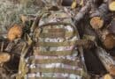 The 5 Best Hunting Day Packs for Alcorn County Deer Season Camouflage hunting backpack resting on logs in the woods