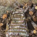 The 5 Best Hunting Day Packs for Alcorn County Deer Season Camouflage hunting backpack resting on logs in the woods