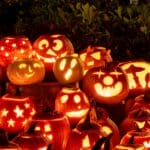 The 5 Best Halloween Lights for Alcorn County Yards and Porches Dozens of carved jack-o'-lanterns glowing orange in the dark on Halloween night, showing the warm light effects Halloween lighting can create.