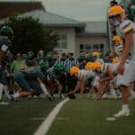 Area Football Scores: Booneville Stays Unbeaten, Bears Win High school football teams play under stadium lights, illustrating area football scores