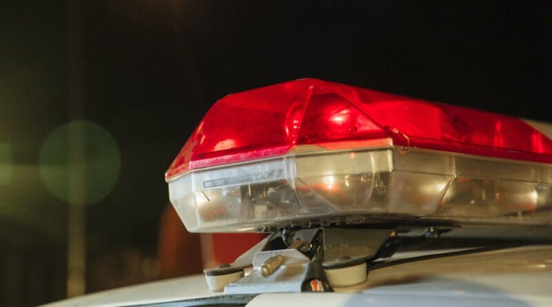 Police car red siren light at night, illustrating a Baldwyn police arrest