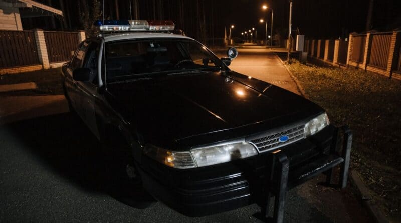 Police car parked on a quiet residential street at night, illustrating the Baldwyn police yard rolling warning
