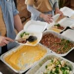 Booneville Ministry Offers Free Weekly Meal, Life Skills Volunteers serving a free community meal like the Booneville ministry meal