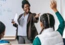 Booneville Schools Earn B Rating; High School Gets an A Teacher answering a student's question in a classroom, illustrating the Booneville school rating