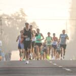 Cat Reman Challenge 5K in Corinth Goes Virtual for Isaias Runners with race bibs on a foggy morning street, illustrating the Cat Reman Challenge 5K going virtual