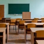 Corinth, Alcorn School Enrollment Dips About 4 Percent Empty classroom with wooden desks and a chalkboard, illustrating a school enrollment decline
