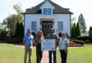 Corinth Beautiful Business of the Month: The Carriage House Four people hold a Beautiful Business of the Month sign in front of The Carriage House in Corinth