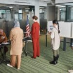 Corinth Mayor Election Tuesday: Where and When to Vote Voters waiting in line at a polling place, illustrating the Corinth mayor election