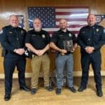 Corinth Police Officer of the Year: Det. Brad Beaty Honored Detective Brad Beaty holds his Corinth Police Officer of the Year plaque beside three fellow officers at the Corinth VFW