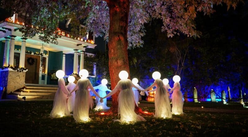 Halloween ghost decorations under a tree in a yard, a scene for Corinth police fall pranks safety tips