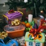Lighthouse Foundation Toy Store Registration Opens Nov. 2 Toys with bows under a Christmas tree, illustrating Lighthouse Foundation Toy Store registration in Corinth