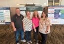 NEMCC, Delta State nursing students present projects at Destin conference Four people stand in front of conference poster presentations in a meeting room.