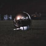 NEMCC Football Hosts Mississippi Delta Tonight in Booneville Football helmet resting on a field at night before an NEMCC football game