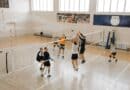 NEMCC Volleyball Sweep Caps Fall Break Homestand Players go up for the ball at the net during an indoor volleyball match, illustrating the NEMCC volleyball sweep