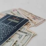 Northeast Mississippi Sales Tax: Corinth Up 4.1% Calculator on top of banknotes representing Northeast Mississippi sales tax diversions