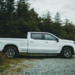 Prentiss County Burglary: County Work Truck Stolen From Shed White crew cab pickup truck parked on gravel, a stock image illustrating the Prentiss County burglary and stolen work truck