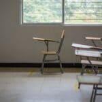 Prentiss County Schools Earn Fifth Straight A Rating Empty classroom with school desks by a large window, illustrating the Prentiss County schools A rating