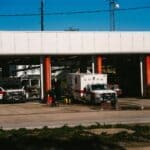 Tishomingo County Sheriff Honors First Responders Day Fire engines and an ambulance parked at a fire station, illustrating National First Responders Day